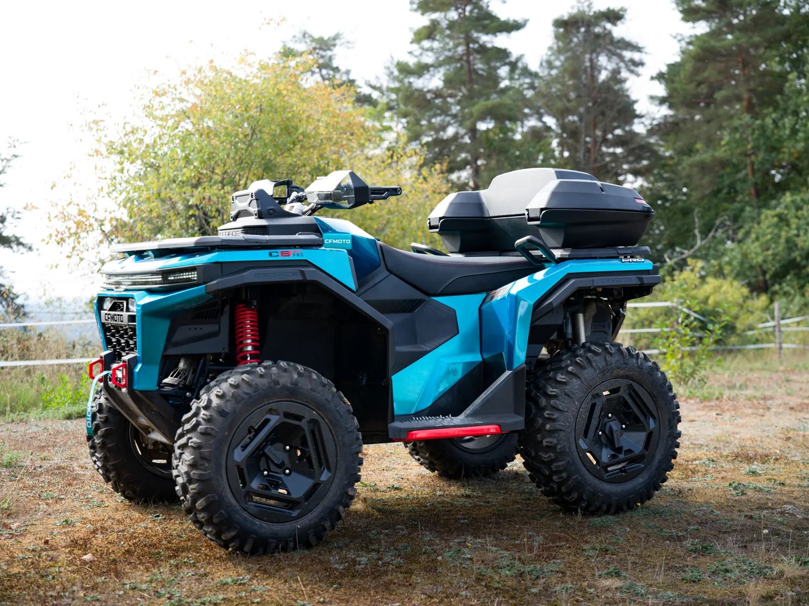 Blue ATV with SmartBox in a wooded setting