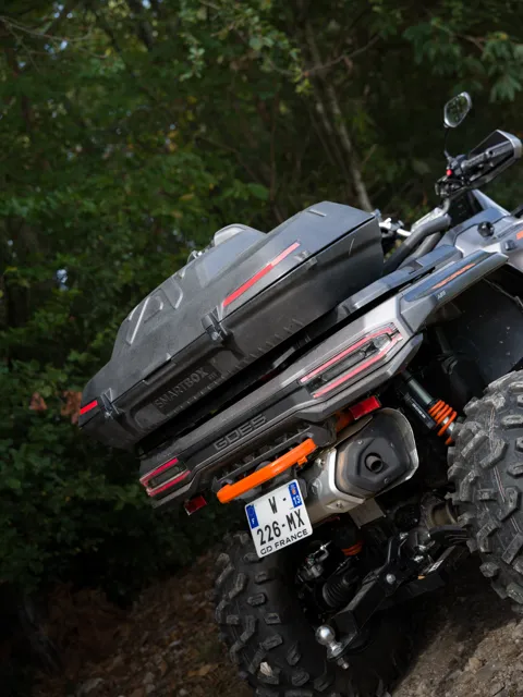 Rear view of an ATV with SmartBox on the trail